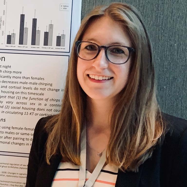 Megan Freiler presents a poster at a conference.