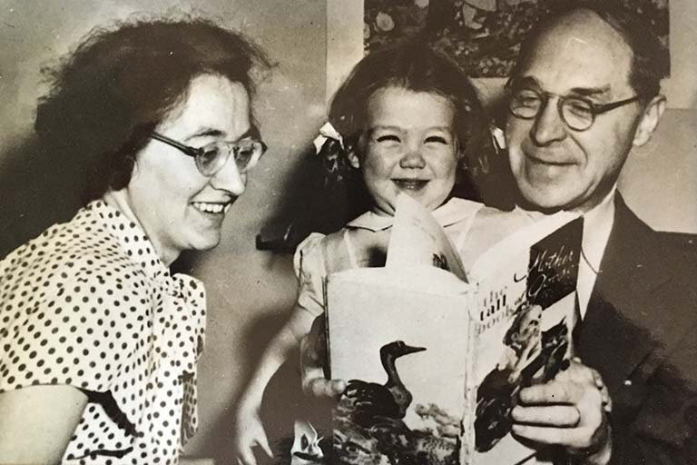 Young Helen Muller smiles as she and her mother Thea (left) and father Hermann pose for their 1946 Christmas card photo. | Photo courtesy of Helen Muller