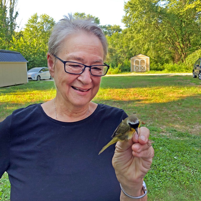 IU Distinguished Professor Ellen Ketterson holds a Common Yellowthroat, a species of warbler.