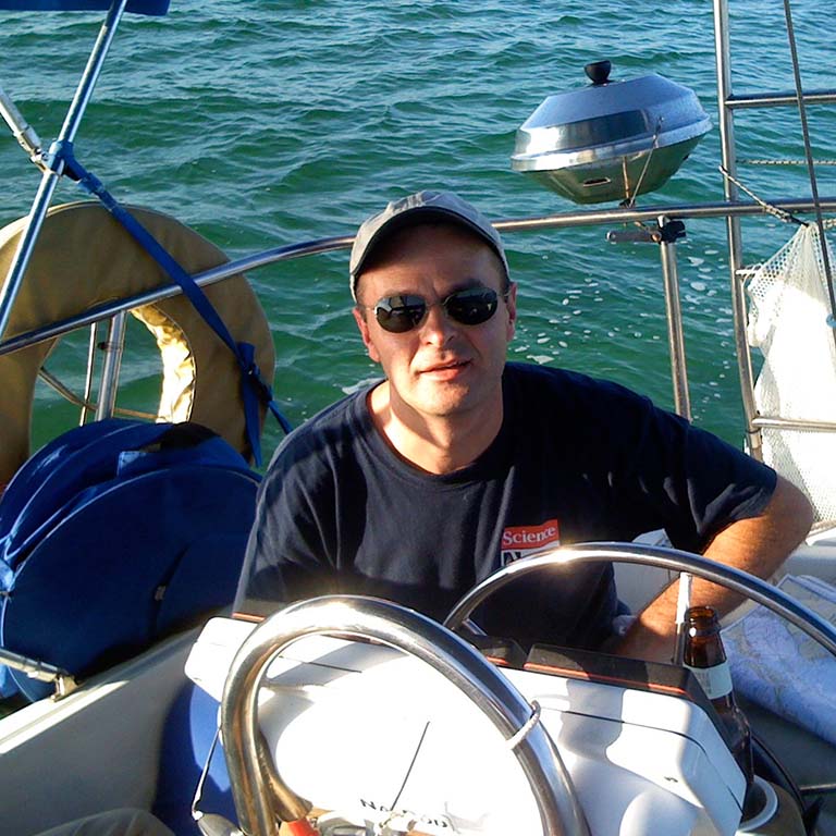 Dan Tracey sits in the captain's seat of the 41-foot rented catamaran which is his transportation for his research excursion in the Caribbean.