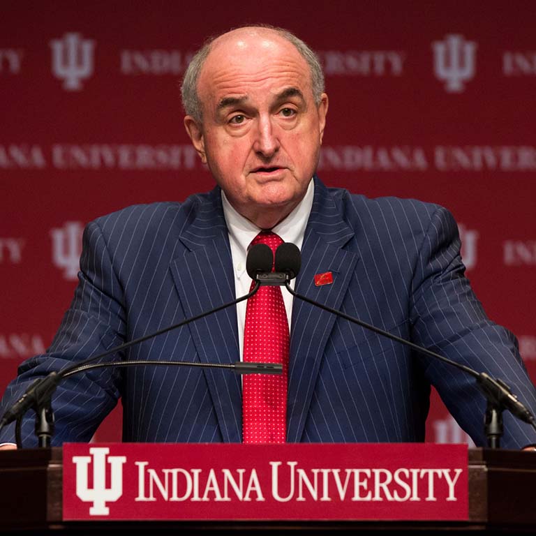 Indiana University President Michael McRobbie standing at a podium.