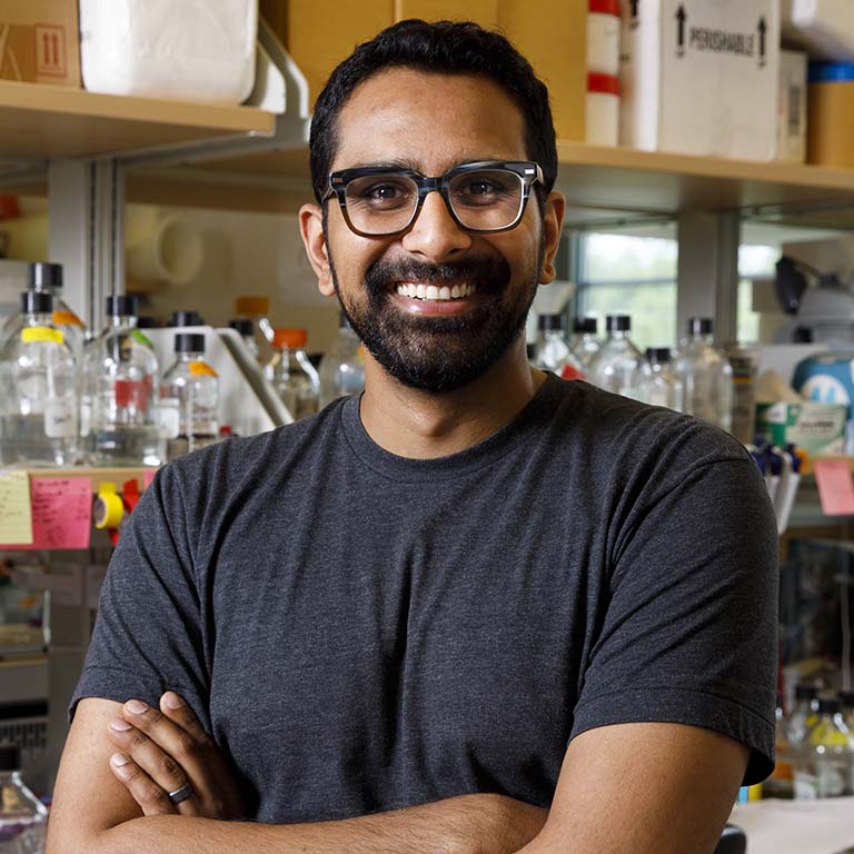 Ankur Dalia poses in front of his lab bench.