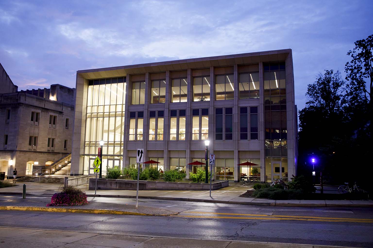 Many lights are on inside the Paul H. O'Neill Graduate Center at the Indiana University O'Neill School of Public and Environmental Affairs on a summer evening on the IU Bloomington campus on Aug. 22, 2019.