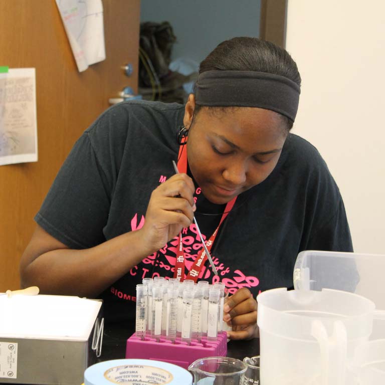 Student working with test tubes.