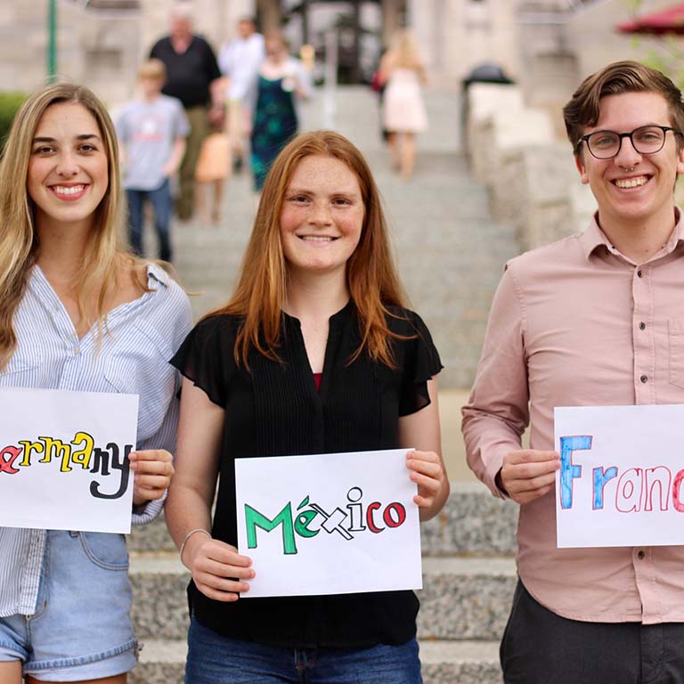 Fulbright Scholar and IU Biology alumna [BS '18, microbiology] Madeline Danforth holds a sign that reads, "Mexico"--where she is teaching English for the 2018-19 Fulbright program.