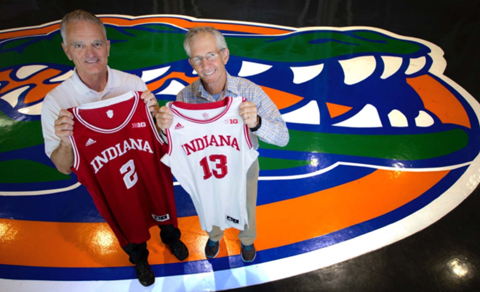 Rob Ferl (left) and Doug Soltis proudly hold up Hoosier basketball jerseys at the Stephen O’Connell Center—home of the Florida Gators—on the campus of the University of Florida, where they both work.