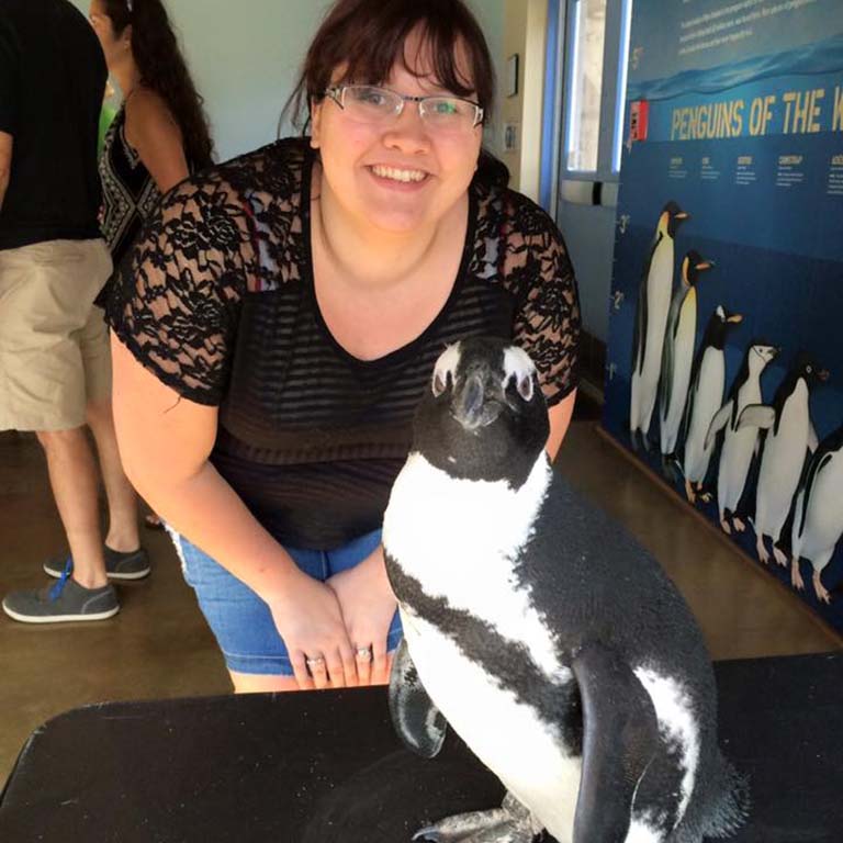 Gabrielle Sell poses with a penguin.